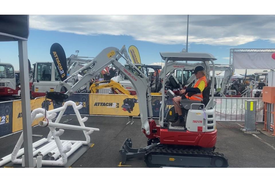 Ashton Simpson trying the Excavator Operator Challenge at the National Diesel Dirt and Turf Expo