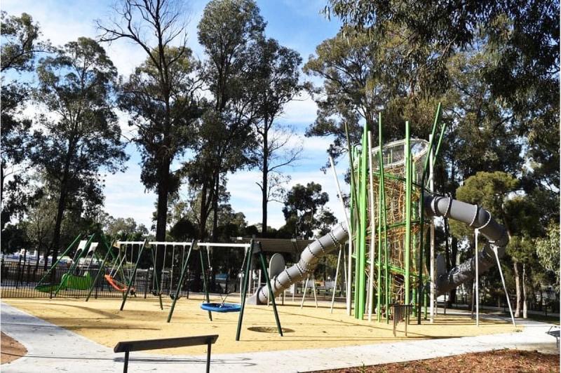 Climbing net fort with slide and swings at Deerbush Park